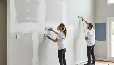 Painter repairing drywall cracks in Wellesley MA home interior for seamless wall restoration